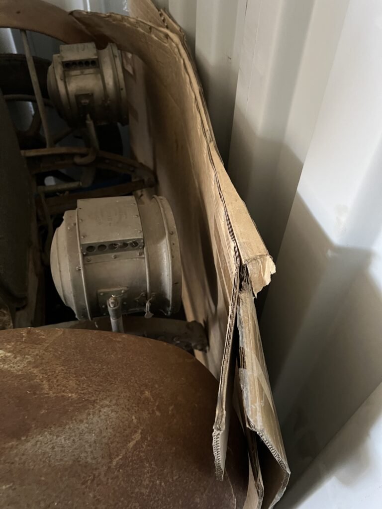 Container Front Axle Tie-Down Straps after Cardboard Packing